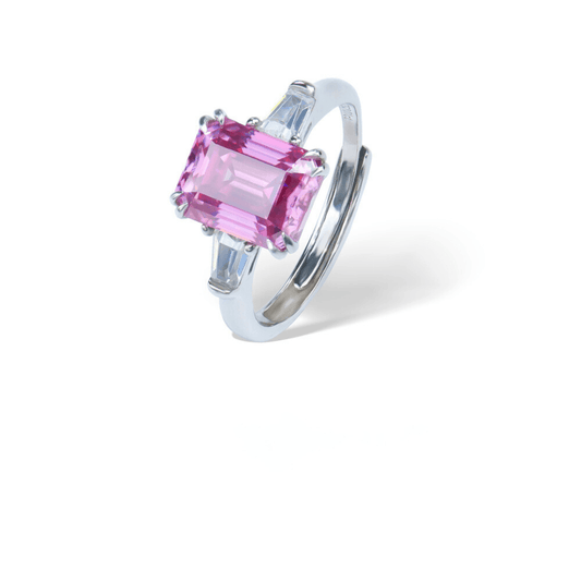 Sakura Emerald Adjustable Ring from the Sparkle Collection, featuring an emerald-cut pink Moissanite set in sterling silver with sparkling accents, displayed on a white background.