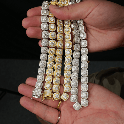 Close-up of hands holding multiple VVS Moissanite Cluster Tennis Necklaces in both gold and silver finishes, showcasing the intricate design and sparkling stones