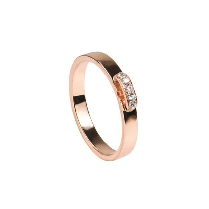 Rose gold ring with a row of sparkling moissanite stones embedded in a sleek and modern design.