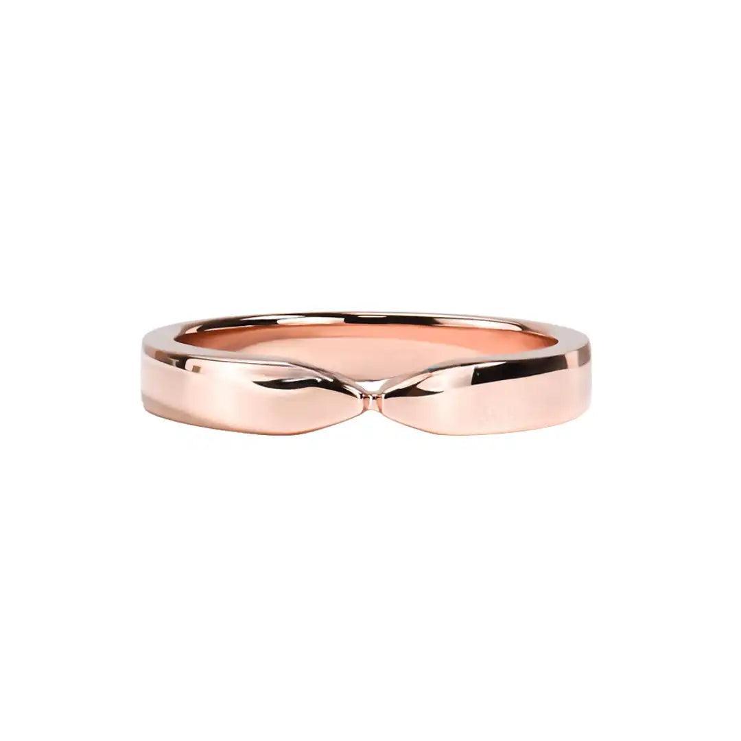 Close-up of a rose gold twist ring lying flat on a white surface, showcasing its elegant curves and shine.