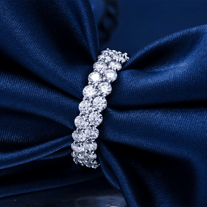 Close-up of the Double Sparkle Moissanite Tennis Ring, highlighting the sparkling moissanite stones against a navy blue fabric