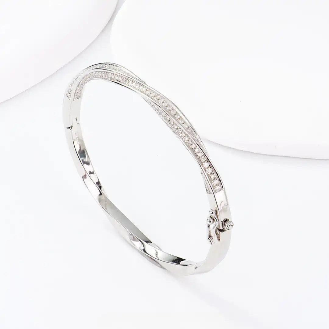 Mozi Mobius Moissanite Bangle displayed against a white background, showcasing its elegant S925 silver design with moissanite stones in a Mobius twist