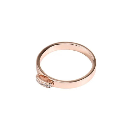 Simple rose gold ring featuring a small cluster of moissanite stones in a horizontal setting.