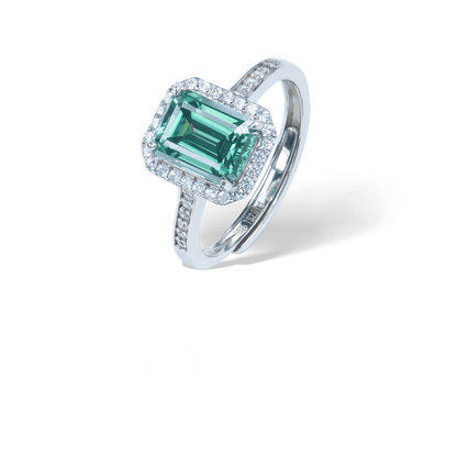 Emerald 2ct Adjustable Ring from the Sparkle Collection, featuring a 2-carat emerald-cut green Moissanite set in sterling silver with sparkling accents, displayed on a white background.