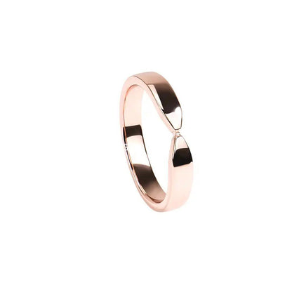 Horizontal view of a rose gold twist ring with a polished finish, elegantly positioned on a white background.