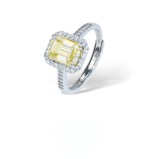 Champagne Emerald Adjustable Ring from the Sparkle Collection, featuring an emerald-cut champagne Moissanite set in sterling silver with sparkling accents, displayed on a white background.