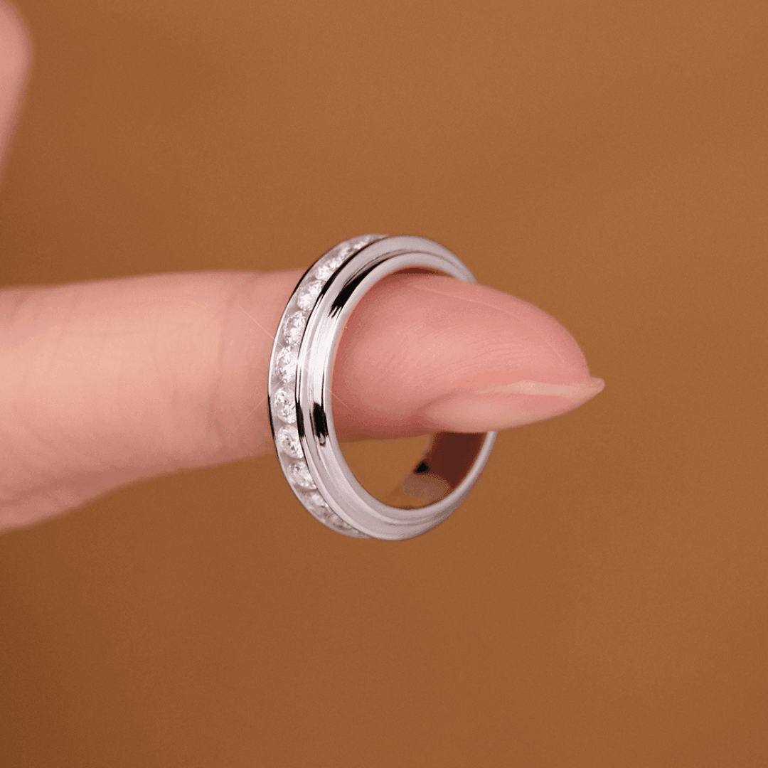 A close-up of a Mozi Twin Sparkle Moissanite Ring, worn on a finger, displaying the ring’s sleek design and radiant moissanite stones.