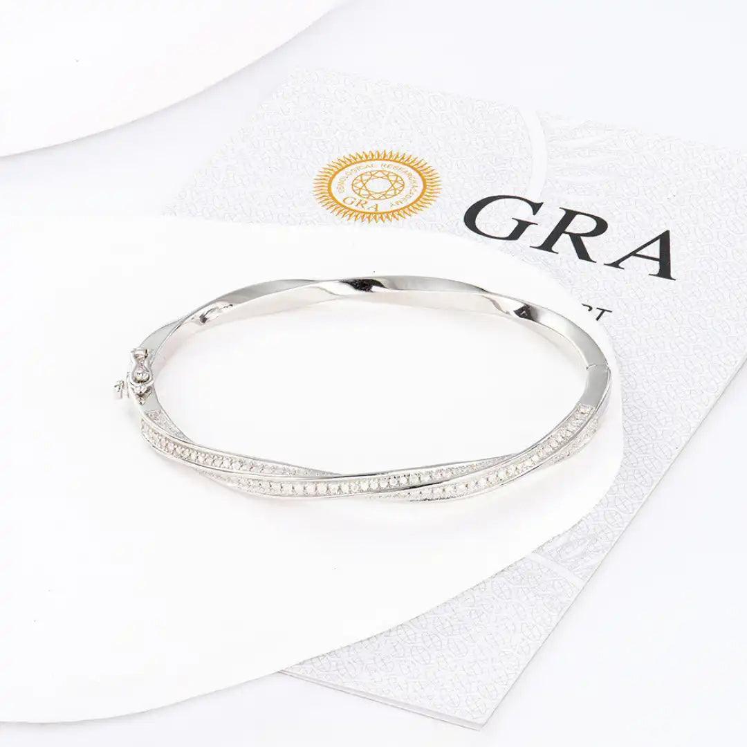 Mozi Mobius Moissanite Bangle displayed on a white surface with a GRA certificate, highlighting the S925 silver design and moissanite stones in a Mobius twist