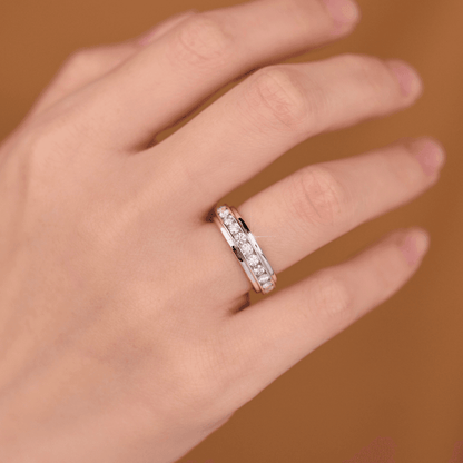 The Mozi Twin Sparkle Moissanite Ring with channel-set stones, worn on a hand, highlighting the ring's intricate design and the brilliant moissanite stones.